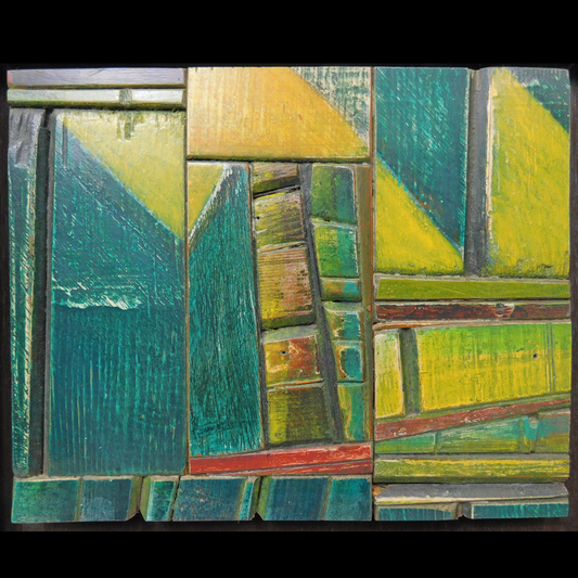Abstract artwork with green blue and yellow hued wood pieces on a white background