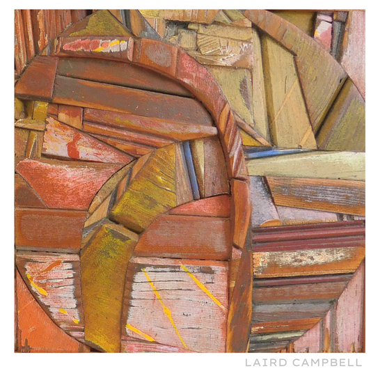 Abstract artwork made from wooden planks with a signature at the bottom