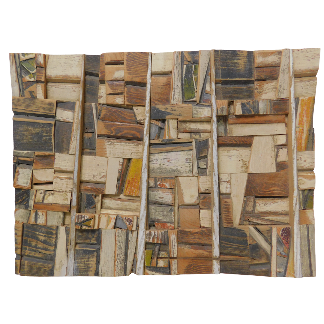 Wooden wall art with a patchwork design on a white background