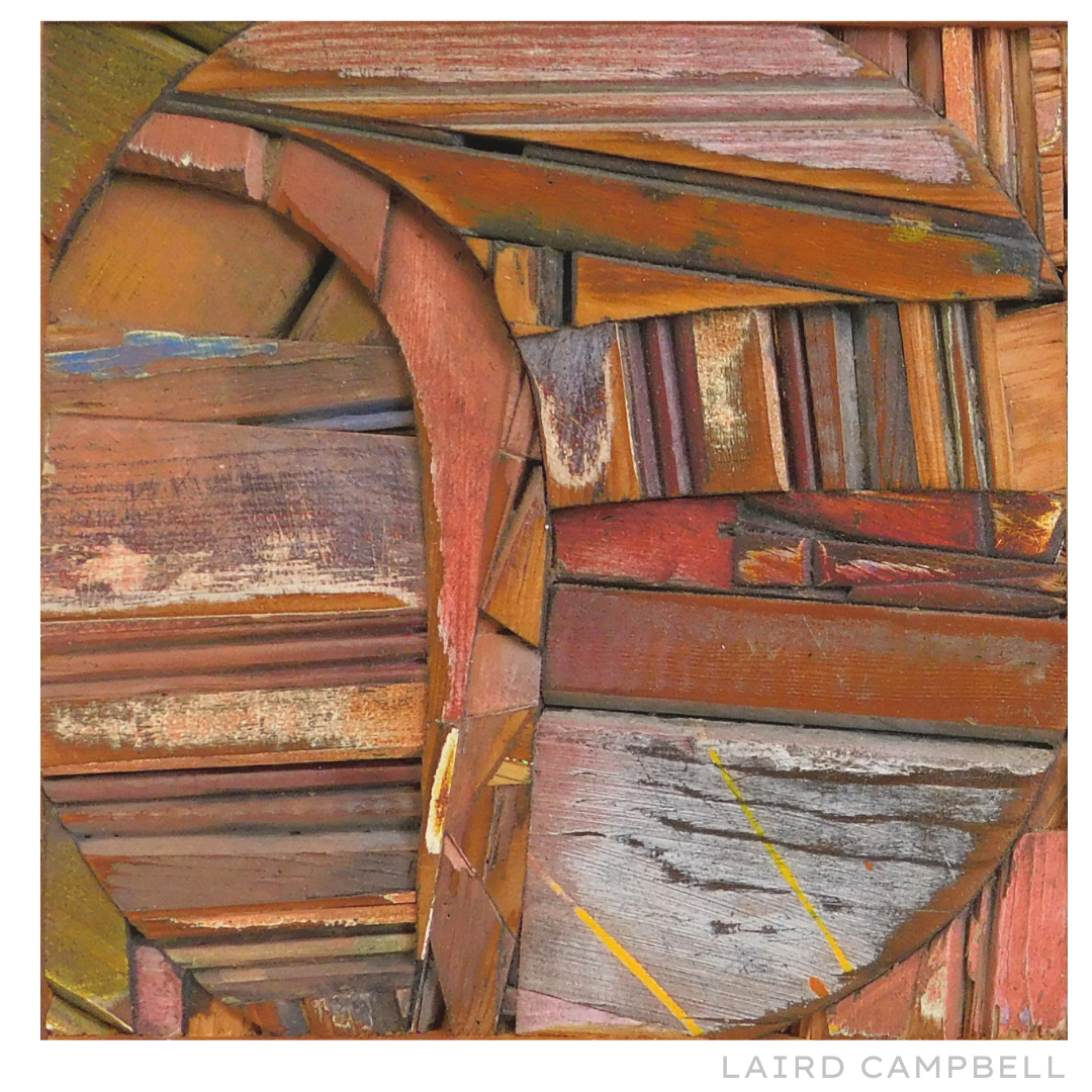 Artwork closeup of wooden assembled pieces with a visible name 'Laird Campbell'.